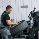 mechanic working on a tire on a table